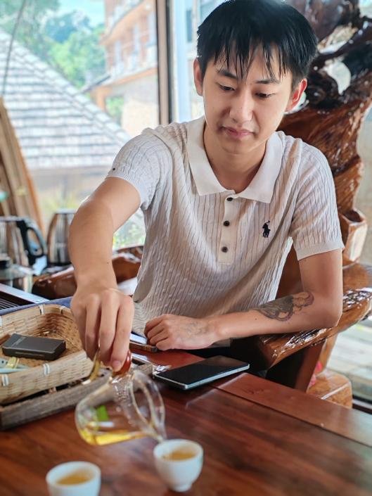 Back to roots:                                                                            Young Luo takes Jingmai tea to World